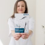 Woman holding a Plexr Shower treatment brochure in a medical aesthetics clinic