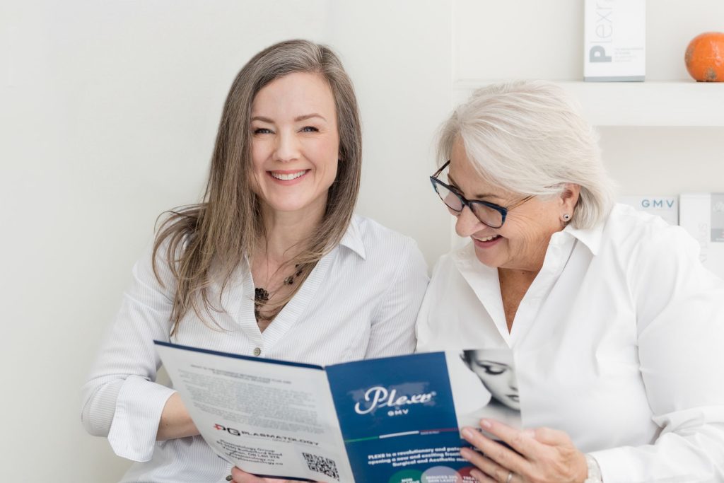 Client and practitioner sharing a lighthearted moment during a Plexr consultation in clinic