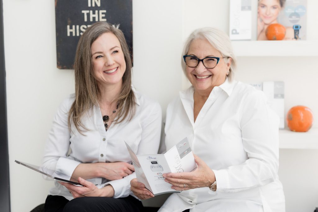 Two women discussing Plexr treatment options during a consultation in a medical aesthetics clinic