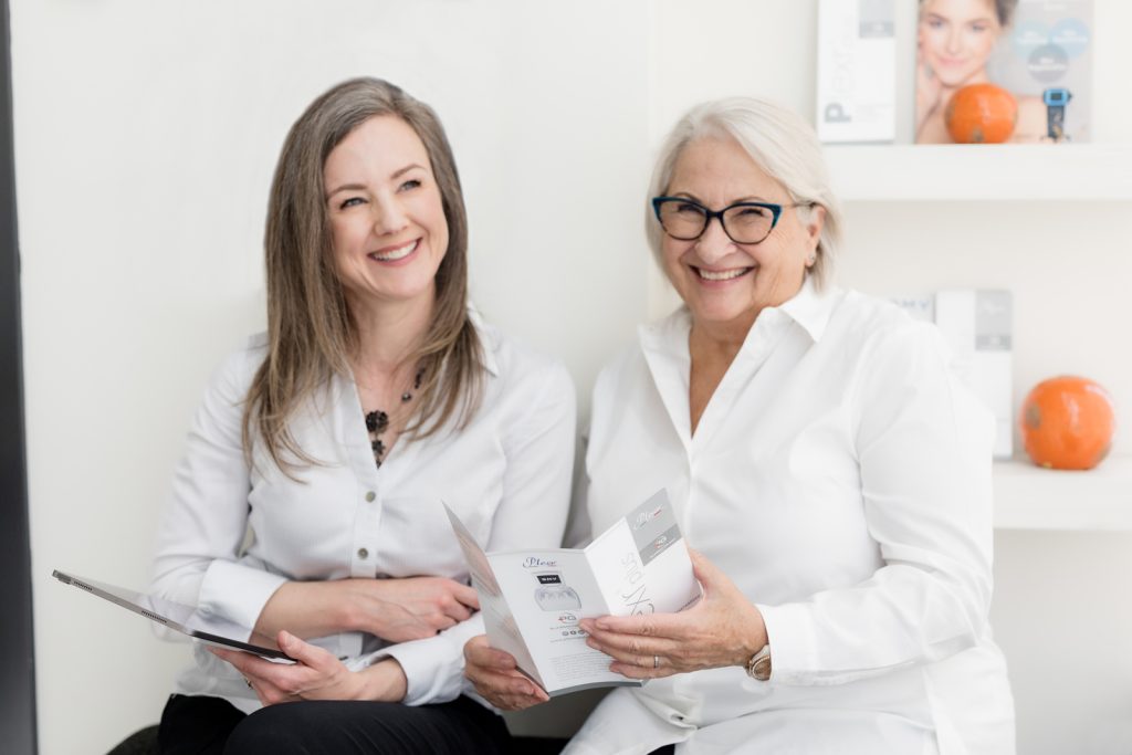 Two women discussing Plexr treatment options during a consultation in a medical aesthetics clinic